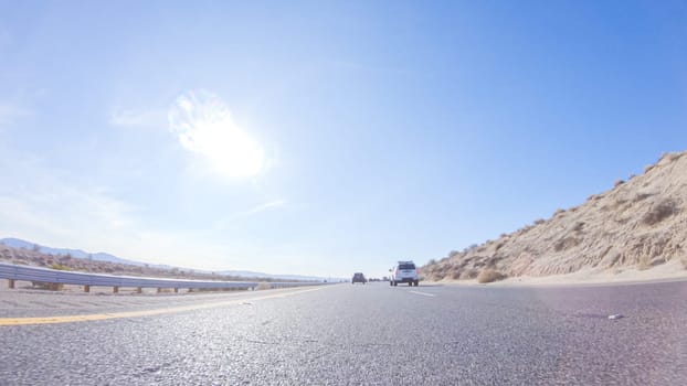 Embarking on a road trip from Nevada to California, driving on Highway 15 during the day offers scenic views and an exciting journey between states.