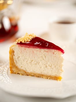 Piece of appetizing cheesecake on restaurant table. Delicious new york cheesecake glazed berries jam