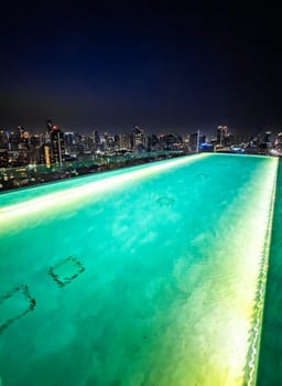 Rooftop pool with Bangkok skyline view at sunset, in Bangkok Thailand, south east asia