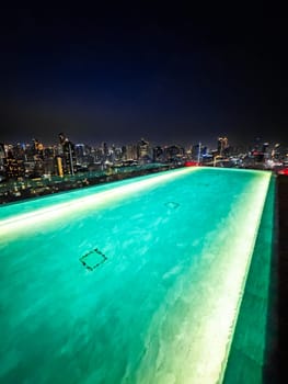 Rooftop pool with Bangkok skyline view at sunset, in Bangkok Thailand, south east asia