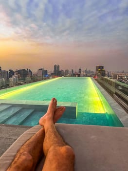 Rooftop pool with Bangkok skyline view at sunset, in Bangkok Thailand, south east asia