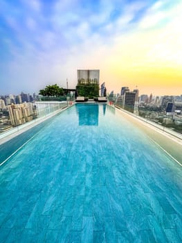 Rooftop pool with Bangkok skyline view at sunset, in Bangkok Thailand, south east asia