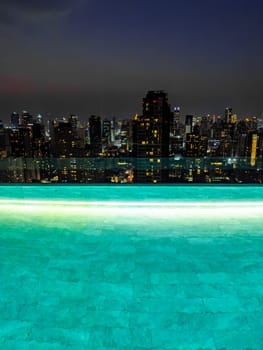 Rooftop pool with Bangkok skyline view at sunset, in Bangkok Thailand, south east asia