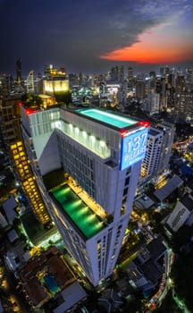 Rooftop pool with Bangkok skyline view at sunset, in Bangkok Thailand, south east asia