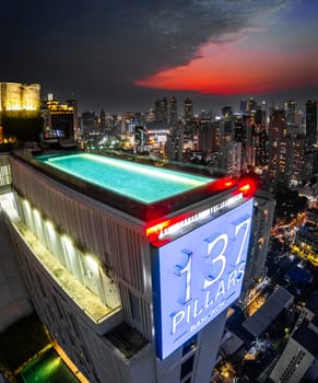 Rooftop pool with Bangkok skyline view at sunset, in Bangkok Thailand, south east asia