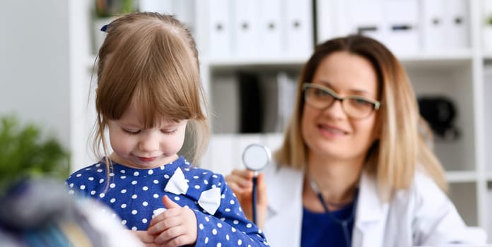 Little child with stethoscope at doctor reception. Physical exam cute infant portrait baby aid healthy lifestyle ward round child sickness specialist clinic test pulse concept