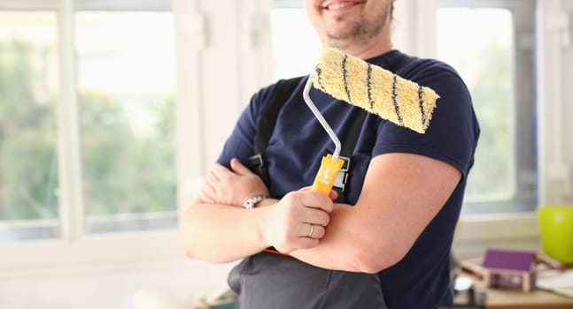 Arm of smiling worker hold brush closeup. Manual job workplace DIY inspiration improvement fix shop yellow helmet hard hat joinery startup idea industrial education profession career concept