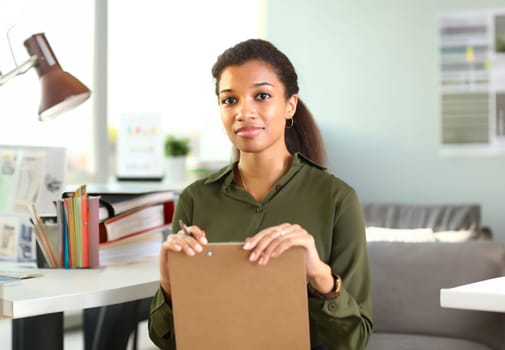 Beautiful black smiling businesswoman portrait at workplace look in camera. White collar worker at workspace exchange market job offer certified public accountant internal revenue officer concept