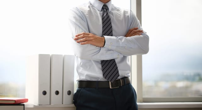 Male hands in suit crossed on chest closeup background. White collar dress code modern office lifestyle graduate college study profession idea coach train election participation concept