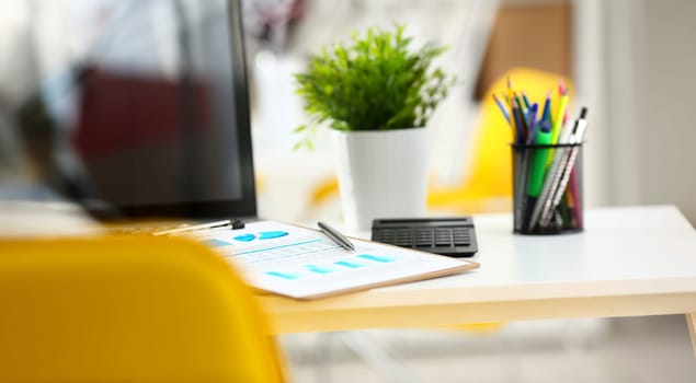 Silver pen lying on important stats paper clipped to pad at table workspace in office closeup. Trade result form paperwork job bank credit loan balance invest payment irs currency audit budget trend