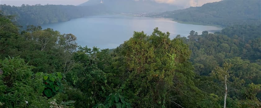 beautiful panorama of beautiful countryside of twin lake in bali. sunny afternoon. wonderful springtime landscape in mountains. grassy field and rolling hills. rural scenery