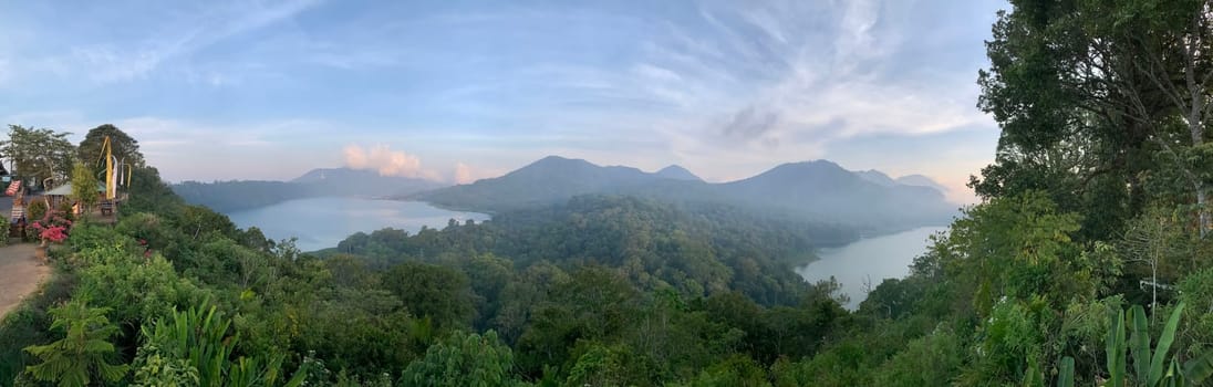 beautiful panorama of beautiful countryside of twin lake in bali. sunny afternoon. wonderful springtime landscape in mountains. grassy field and rolling hills. rural scenery