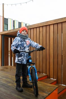 Boy riding a bike during winter holidays.