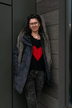 Lifestyle concept, young European woman with pigtails in her hair walking around the city.