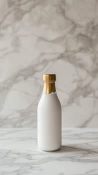 A white and gold bottle on a marble counter top