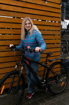 European woman with blond hair went out for a bike ride in winter.