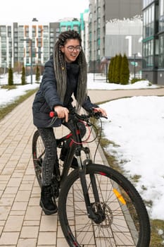 Bike rental concept, young european woman riding a bike around the city.