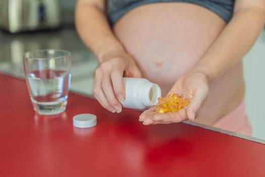 pregnant woman conscientiously takes fish oil capsules, rich in omega-3, prioritizing essential nutrients for a healthy pregnancy journey.