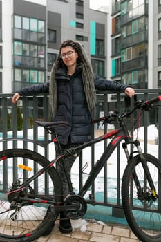 Urban pretty woman with dreadlocks hair rented a sports bike for the weekend.