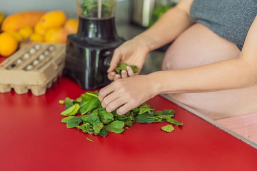 Embracing a nutritious choice, a pregnant woman joyfully prepares a vibrant vegetable smoothie, prioritizing wholesome ingredients for optimal well-being during her maternity journey.