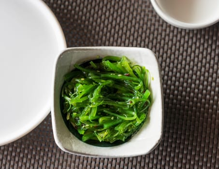 Top view of a bowl of Wakame seaweed salad, typical dish in East Asia.