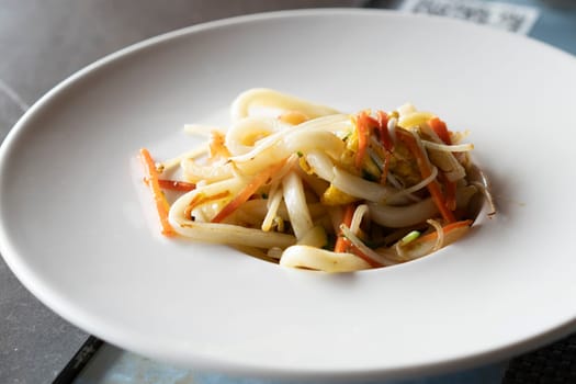 Stir-fried Yaki Udon noodles with shrimps seafood, vegetables and soy-based Sauce. Japanese food.