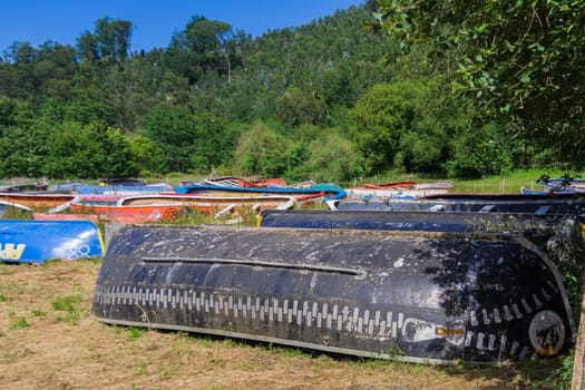 Boats are stored outdoors on the grass