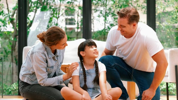 Parents comforting their daughter with loving embrace, helping her feel secure and protected as she rest her head on their shoulder. Happy family love and child care support Panorama. Synchronos