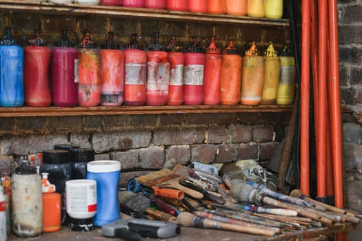 Jars with acrylic paints at a workshop of artist