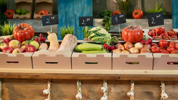 Locally grown organic produce on farmers market counter with fresh bio agricultural farming stand. Various colorful natural eco fruits and vegetables lying on stall at autumn festival.