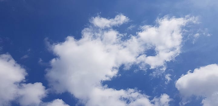 Heavenly white clouds on the blue sky with the sun appeared perfect for multimedia texture or background and content creation