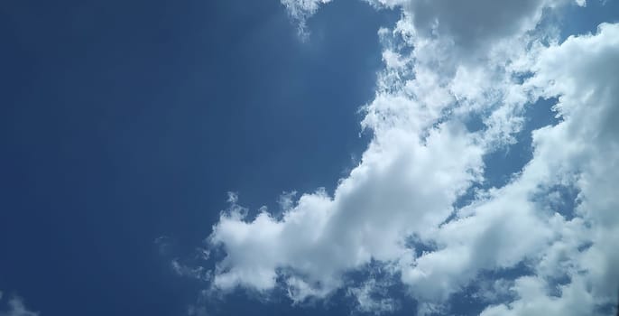 Heavenly white clouds on the blue sky with the sun appeared perfect for multimedia texture or background and content creation