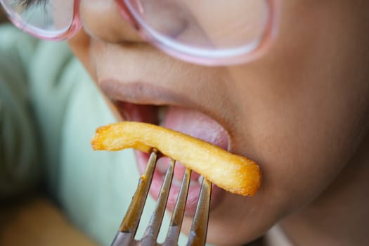 child eating french fries close up ,