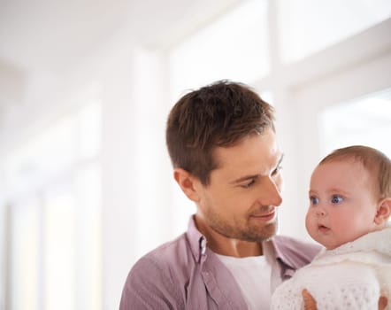 Father, baby and home with love, support and bonding together with newborn and smile. Happy, family and dad with young child in a living room with parent care in a house carrying a calm infant.