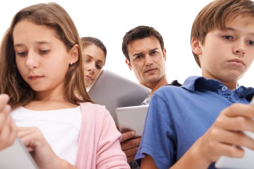 Mother, father and children with tablet on a white background for internet, website or online games. Family, ignore and mom, dad and kids on digital tech for streaming, connection or videos in studio.