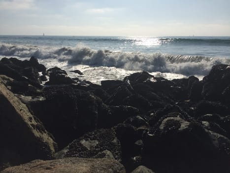 Waves Crashing along Rocky Shore near Los Angeles, California. High quality photo