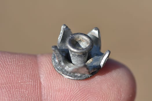 Closeup of a Snow Spike for Winter Hiking on my Finger . High quality photo