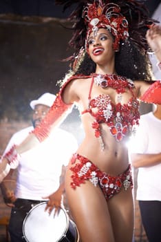 Black woman, dancing and samba with band at night for carnival season celebration in Rio de janeiro with sequins costumes. Female person, happy and fun at festival with unique fashion for culture.