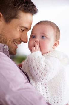 Dad, baby and home with love, support and bonding together with newborn and smile. Happy, family and father with young child in a living room with parent care in a house carrying a calm infant.