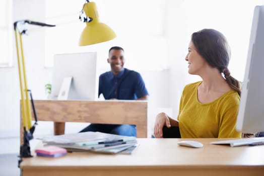 Colleagues, office and working on computer, smile and in work space. Collaboration, journalist or writer at newspaper company, technology and magazines with communication between news bloggers.