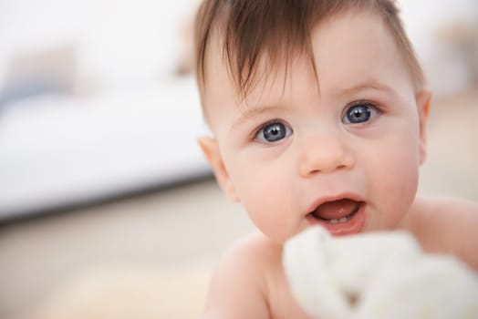 Happy, baby and portrait for growth and development with face of infant with innocence. Toddler, adorable and cute, smiling and teething for childhood and young at home or in nursery for play.