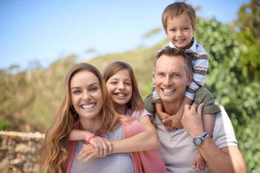 Parents, children and portrait with smile for travel together or vacation bonding in summer or family, sunshine or relax. Mother, daughter and siblings on shoulders in Florida or garden, park or love.