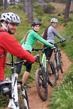 Cycling, portrait and sports people in nature for race, journey and training in competition or travel on path in forest. Group, athlete or friends on bicycle for exercise and cardio on the mountains.