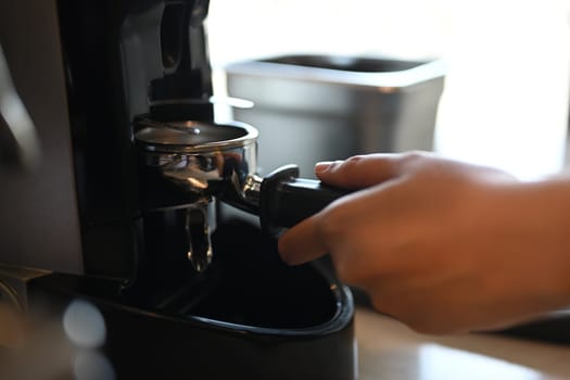 Close up barista using coffee machine, preparing espresso in a coffee shop or restaurant.