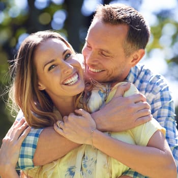 Portrait, embrace and happy couple with smile in park for summer romance, trees and fun outdoor date. Love, mature man and woman in garden with morning sunshine, hug and marriage bonding in nature