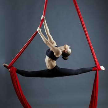 Image of graceful gymnast performing aerial exercise