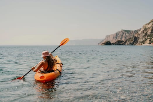 Kayak sea woman. Happy attractive woman with long hair in red swimsuit, swimming on kayak. Summer holiday vacation and travel concept