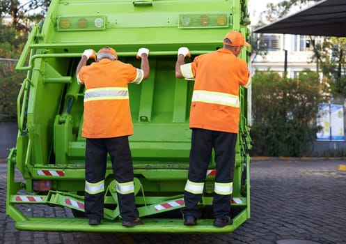 Garbage truck, men and service for waste management and teamwork with routine and cleaning the city. Employees, recycle and environment with transportation and green energy with trash and sanitation.
