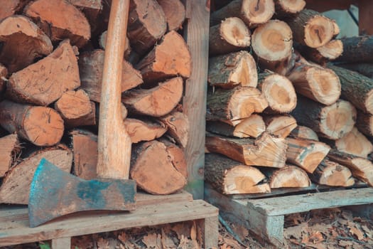 Woodshed firewood made from wooden tree trunks cut with ax. High quality photo