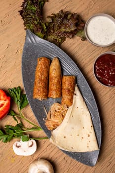 Healthy chicken kebab skewers with grilled veggies and herbs on rustic table.